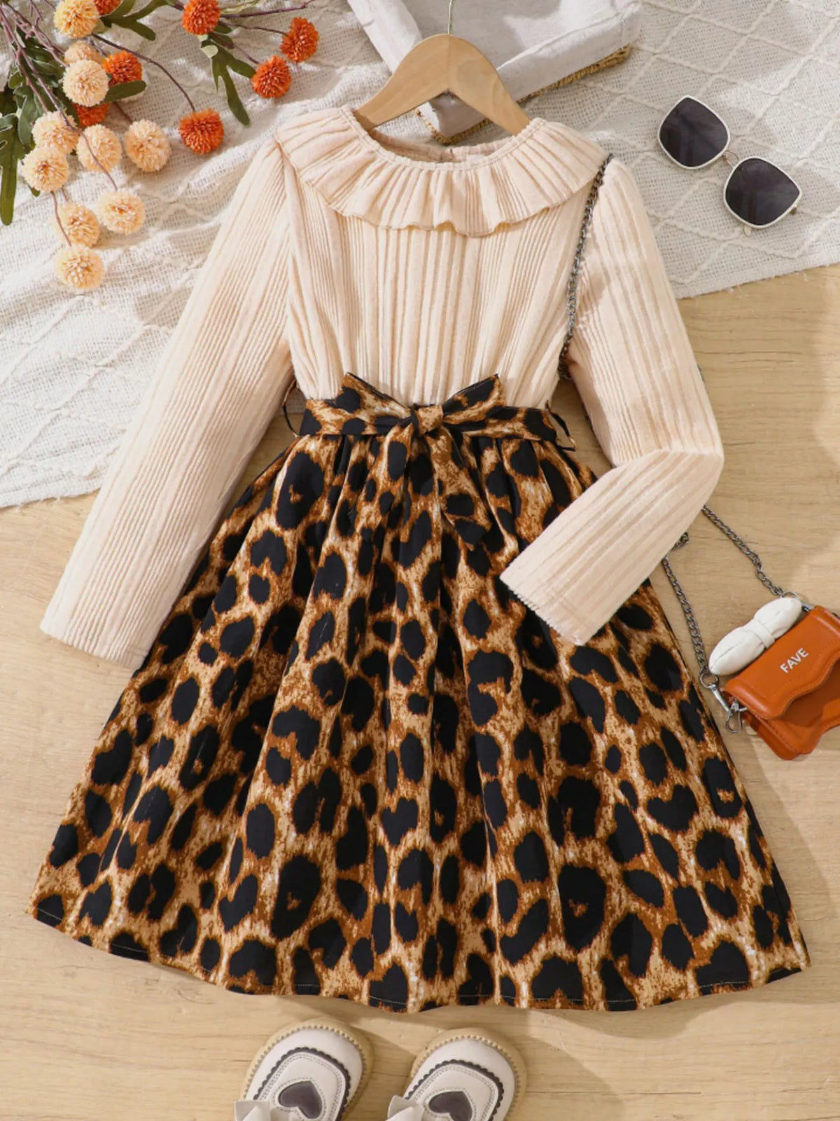 Baby apricot dress with leopard print skirt, ruffle collar, and bow detail.
