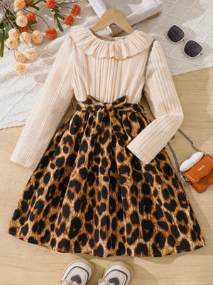 Baby apricot dress with leopard print skirt, ruffle collar, and bow detail.