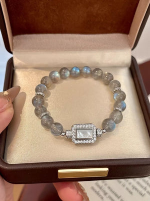 Iridescent moonstone beaded bracelet with a rectangular mother-of-pearl and crystal charm.