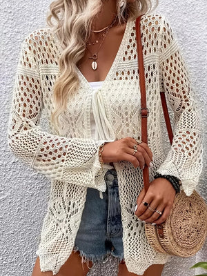 Cream crochet knit cardigan with V-neck, tie front, and bell sleeves.