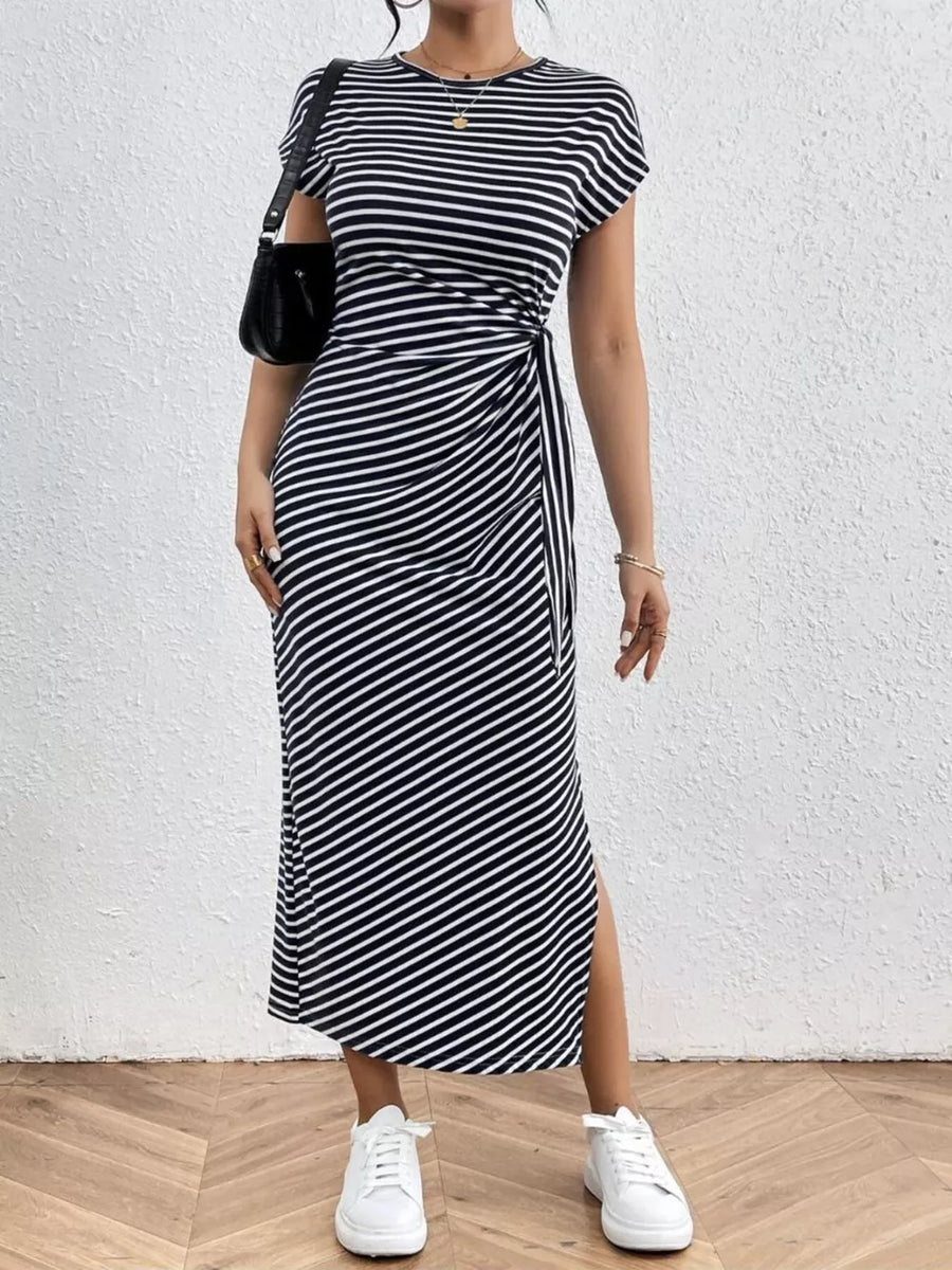 Black and white striped midi dress with tie-side detail and leg slit.