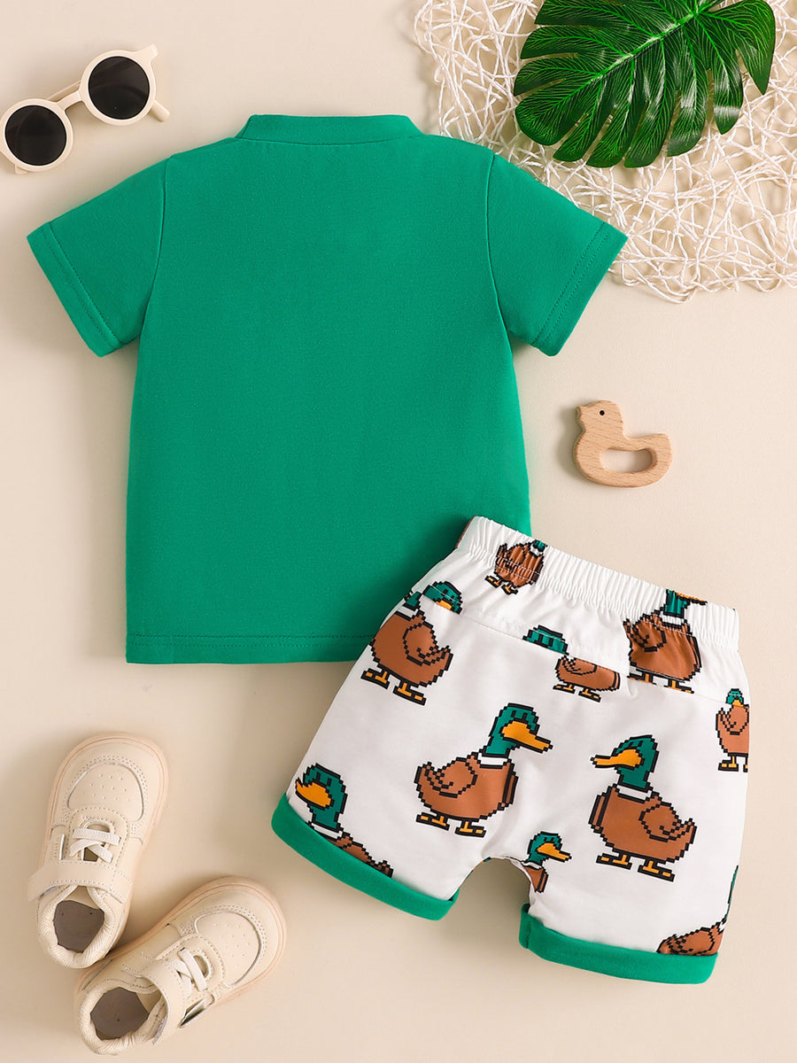 Green baby tee and white duck print shorts set with green trim.