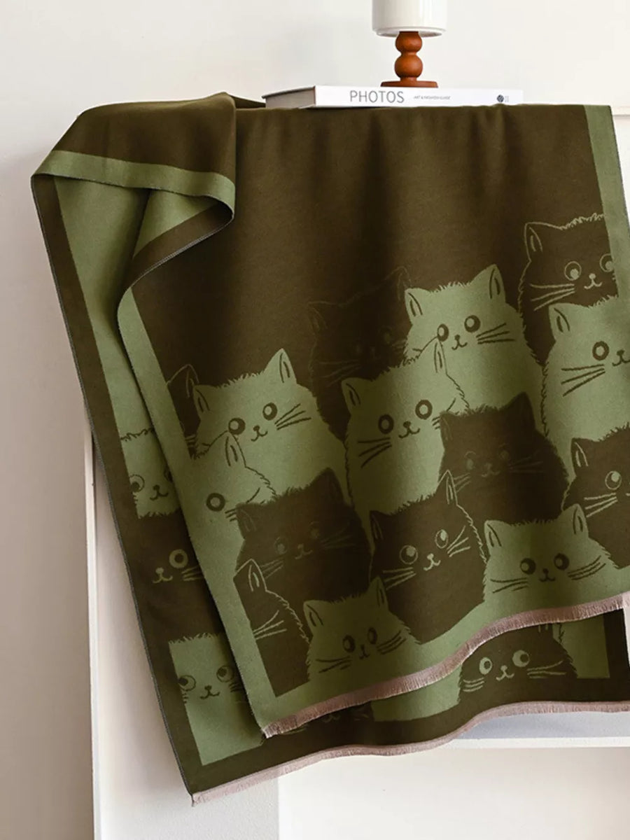 Reversible scarf in dark brown and green with a cute cat pattern.