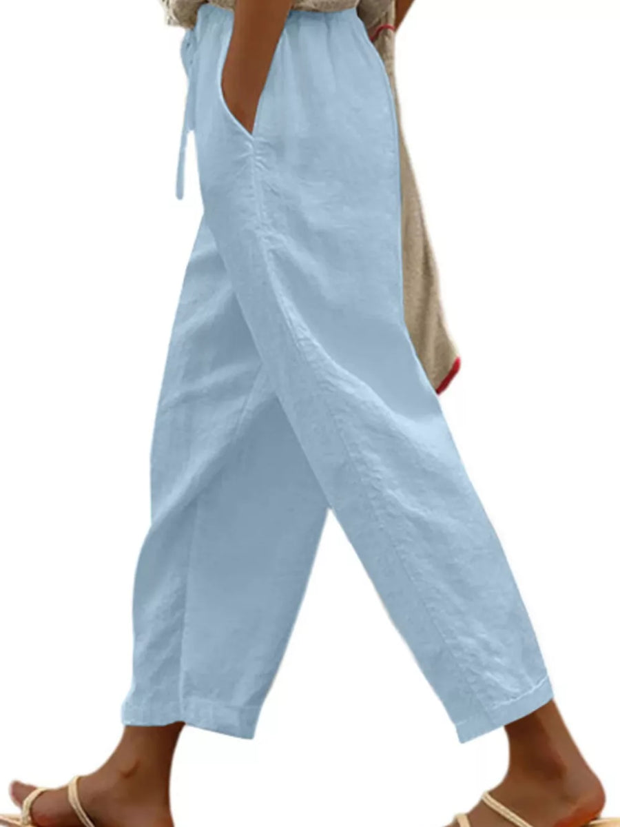 Light blue relaxed fit cropped maternity pants with drawstring waist and pockets.