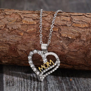 Silver heart necklace with crystal accents and gold MOM lettering.