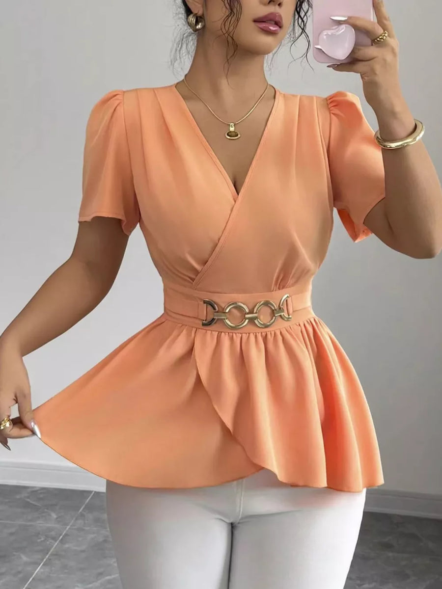 Orange surplice peplum blouse with belted waist and short puff sleeves.