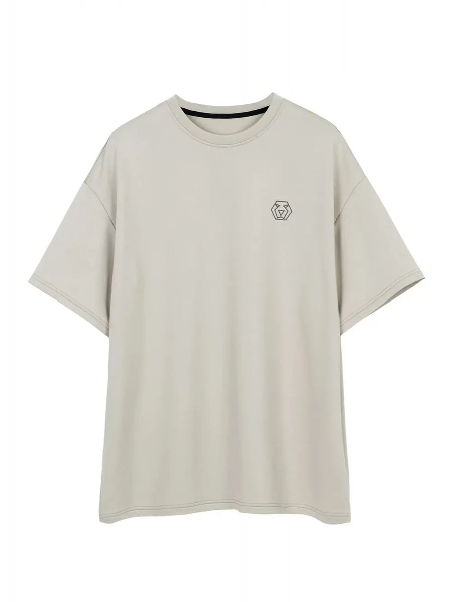 Oversized gray t-shirt with minimalist emblem logo and crew neck.