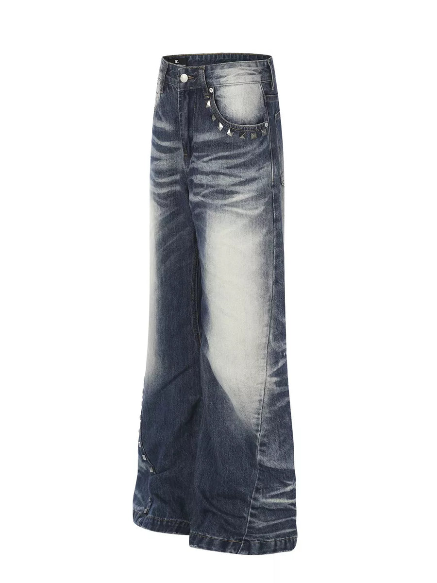 Blue distressed bootcut jeans with studded accents on the pockets.