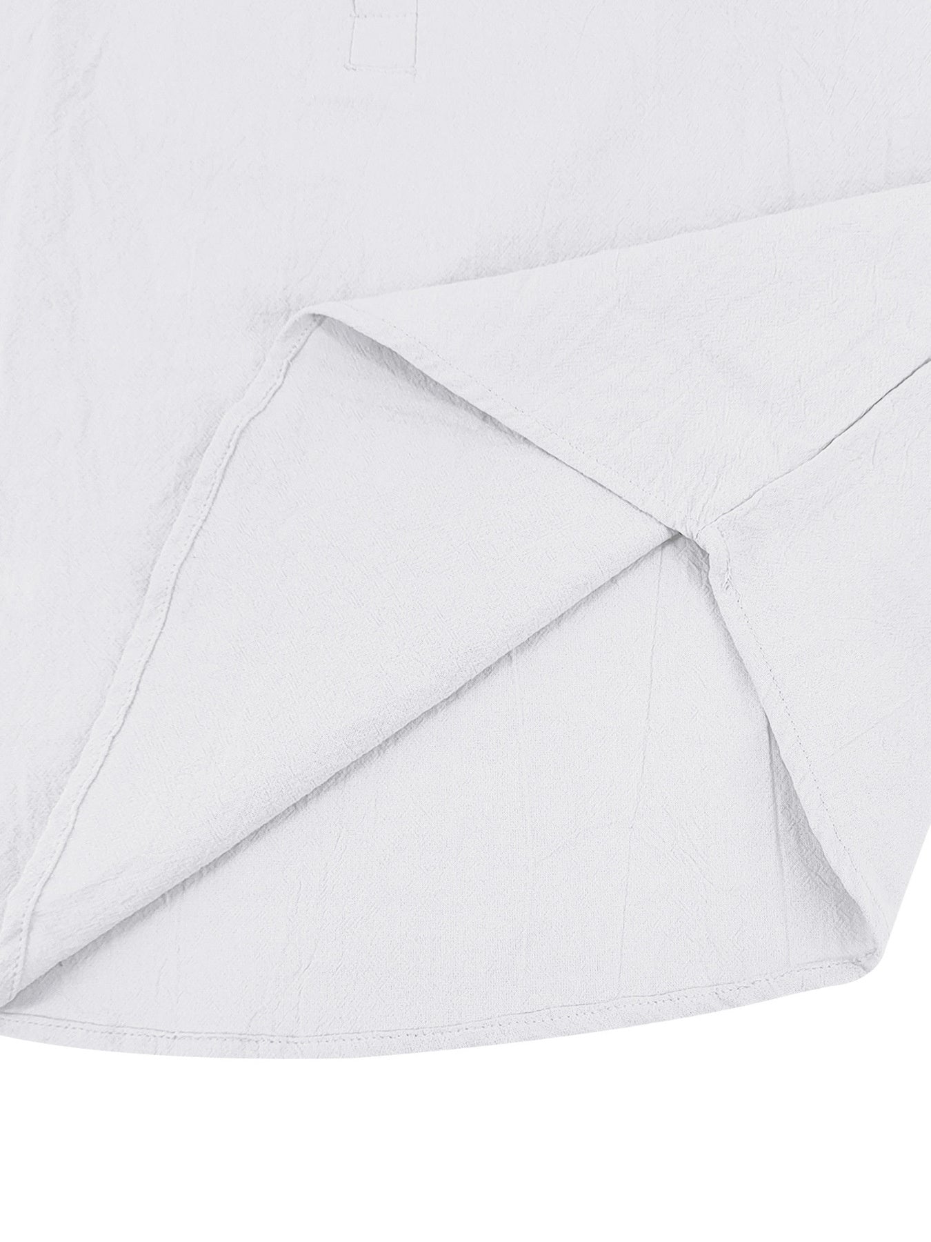 White cotton button-down shirt detail showing hem and side seam construction