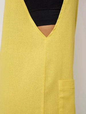 Yellow cotton romper with V-neck and patch pocket detail