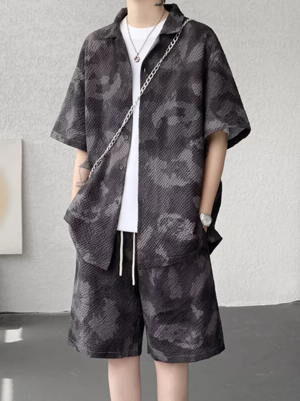 Men's dark gray camouflage short sleeve shirt and shorts set with textured fabric.
