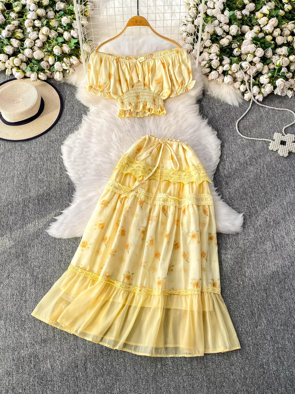 Yellow floral ruffled off-shoulder crop top and tiered midi skirt set with lace trim.
