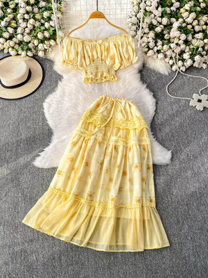 Yellow floral ruffled off-shoulder crop top and tiered midi skirt set with lace trim.