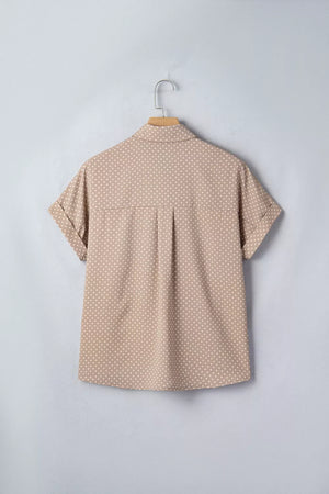 Chic polka dot button-up shirt with cuffed short sleeves and a collared neckline.