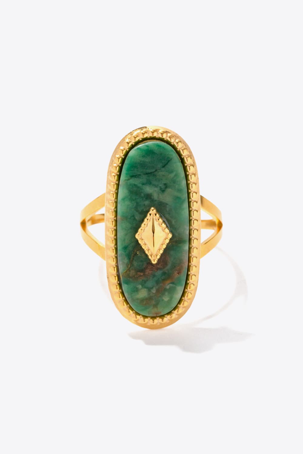 Gold-plated ring with oval green emerald stone and diamond accent