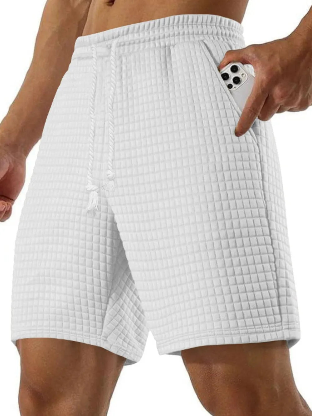 White waffle knit relaxed fit shorts with drawstring and pocket detail.