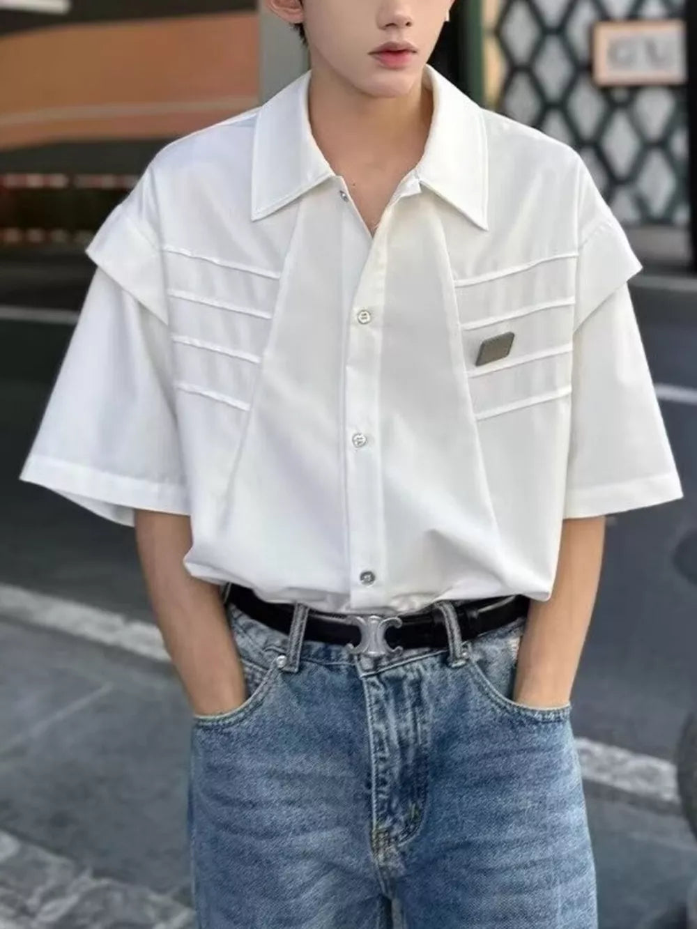 White relaxed fit oversized button-up shirt with chest pleats and short sleeves.