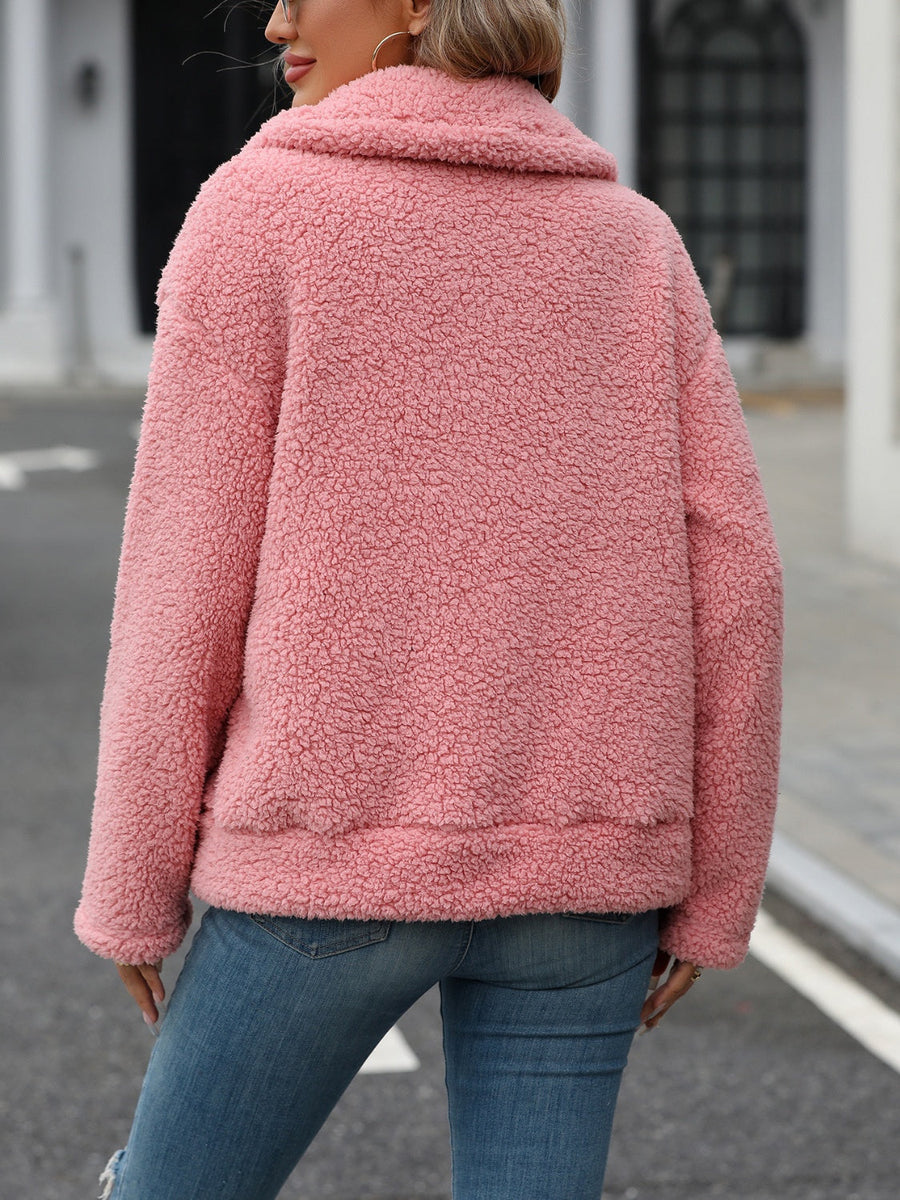 Teddy shearling zip-up jacket in burnt coral with a plush texture and collar.