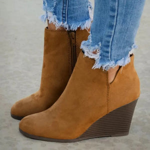 Ochre wedge ankle boots with side zipper and distressed denim.