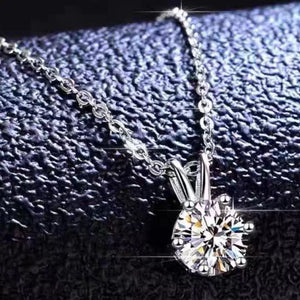 Elegant moissanite pendant necklace in sterling silver with a delicate chain.