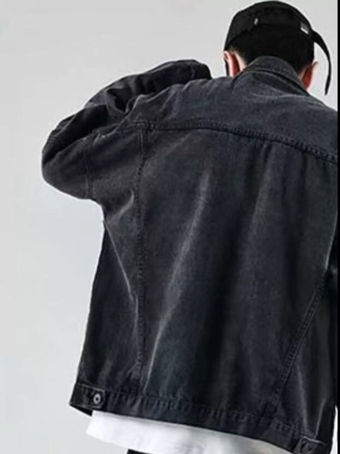 Men's black denim trucker jacket with button details and classic stitching.