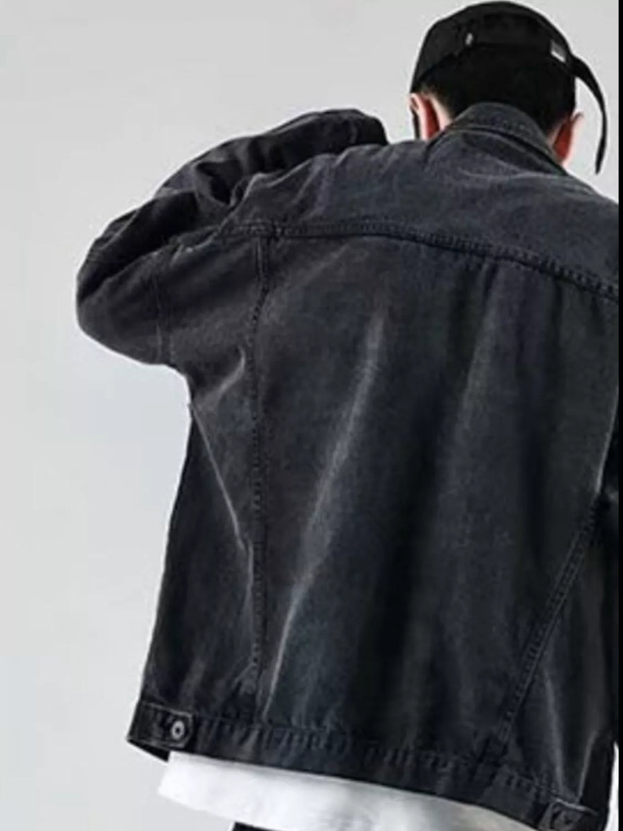 Men's black denim trucker jacket with button details and classic stitching.