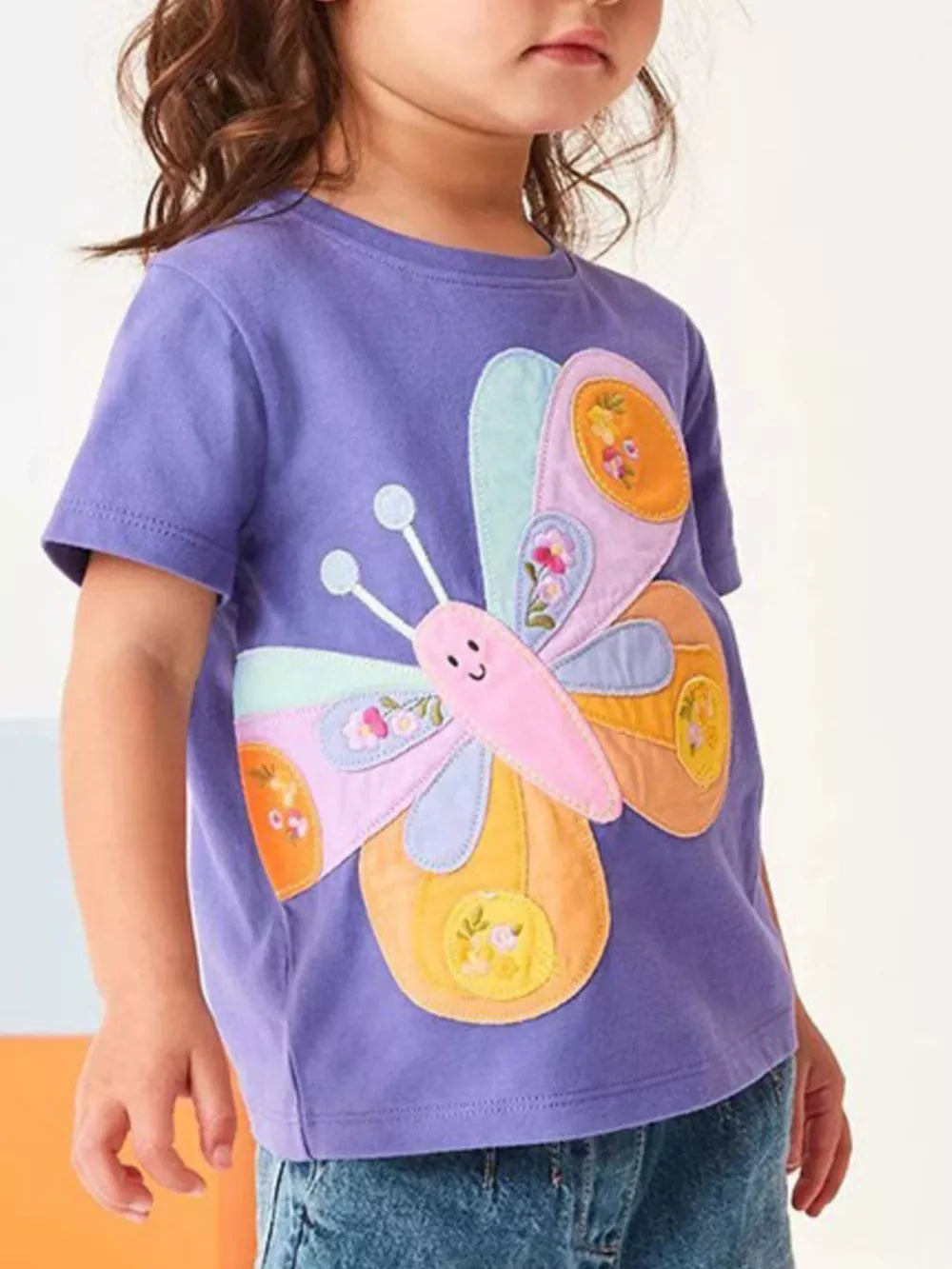 Purple cotton toddler t-shirt with a colorful butterfly appliqué and embroidered floral details.