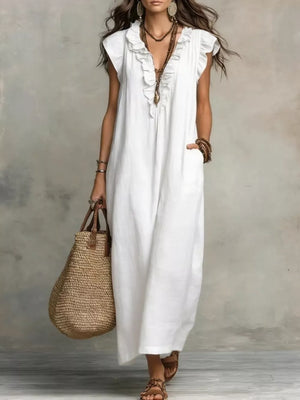 White ruffled V-neck maxi dress with pockets and short sleeves.