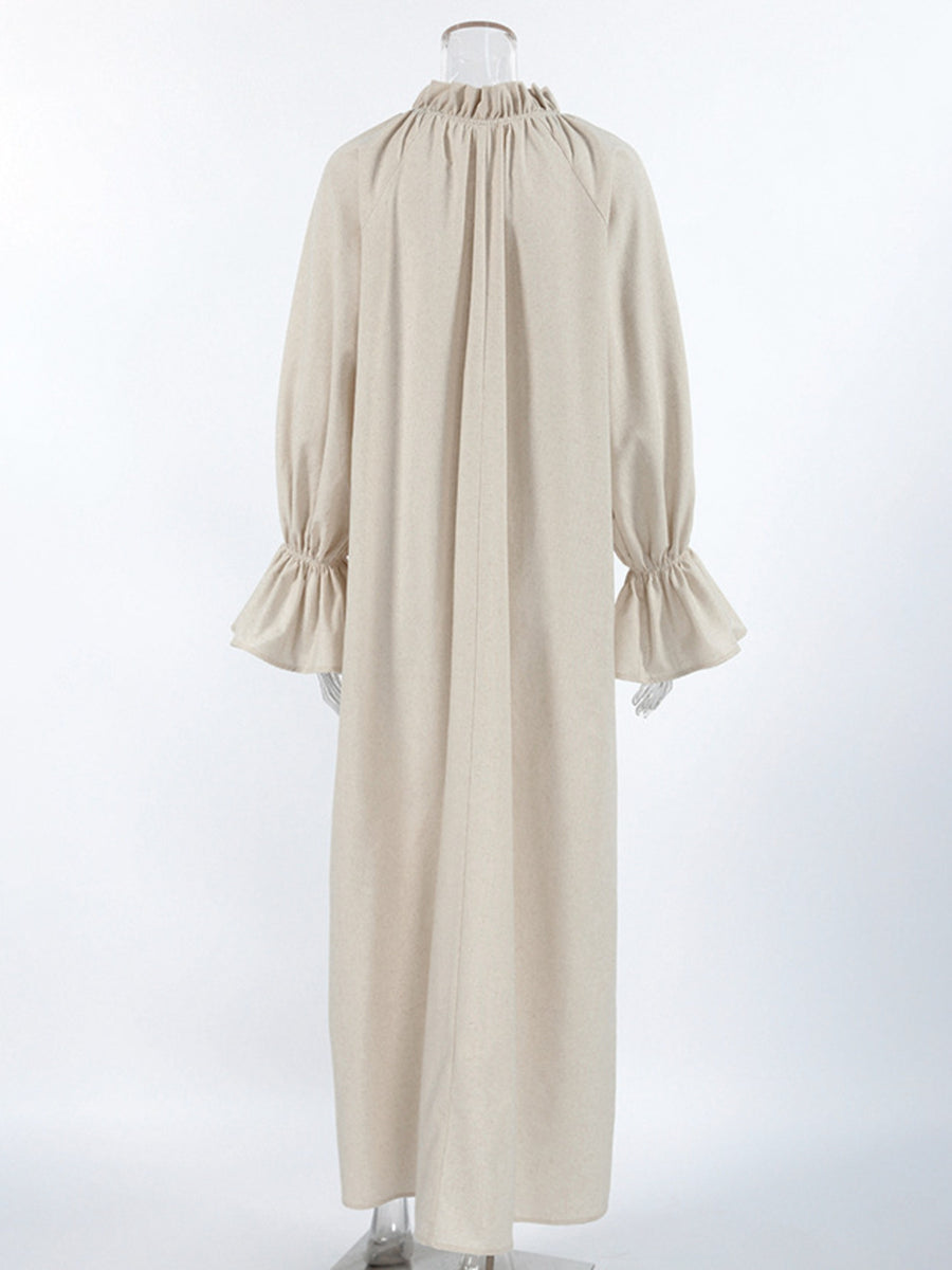 Beige cotton maxi dress with tie neck, ruffled collar, and ruffled cuffs.