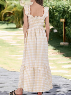 Apricot gingham midi dress with smocked bodice and ruffled sleeves.