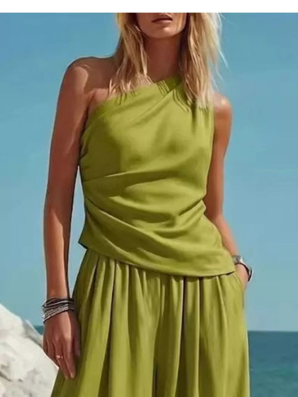 Green one-shoulder draped top and wide-leg pants set with a relaxed fit.