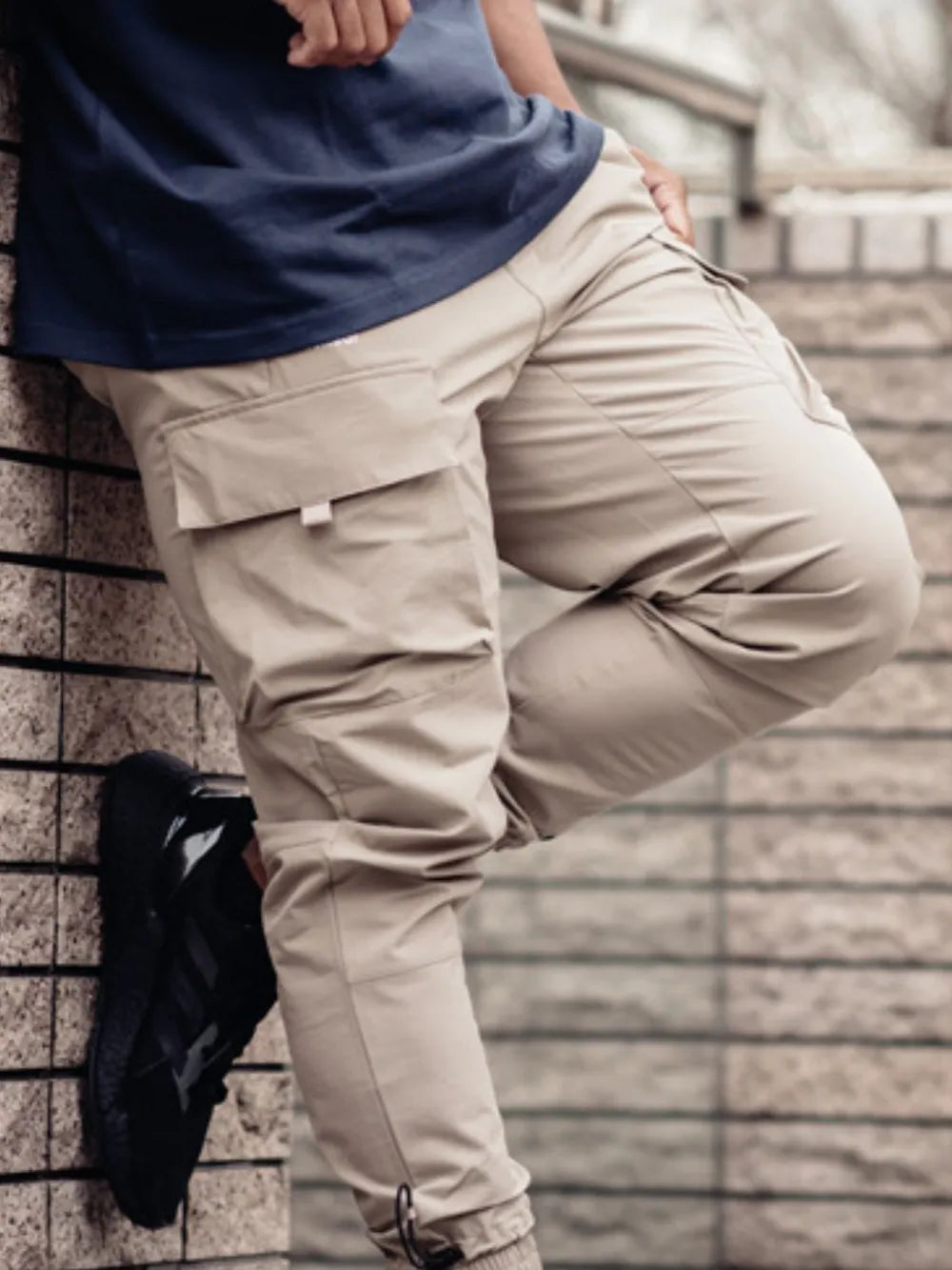 Tech-utility cargo joggers in mocha with drawstring and multiple pockets.