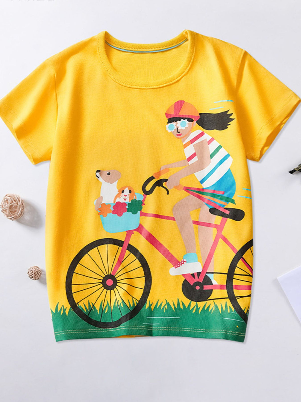 Yellow cotton crew neck t-shirt with bicycle adventure graphic featuring a girl and pets.