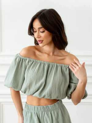 Green cotton off-shoulder cropped top with puff sleeves and matching high-waisted shorts set.