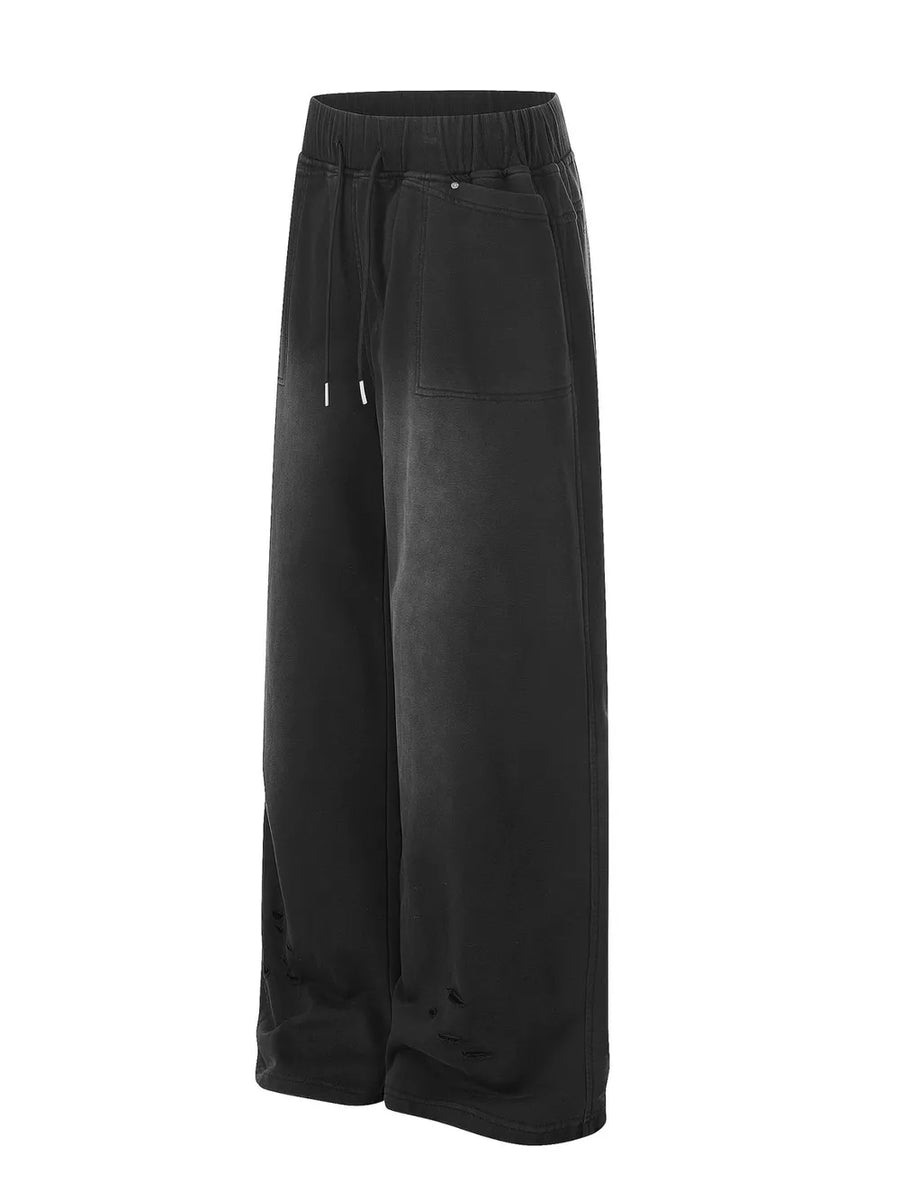 Black distressed wide-leg drawstring sweatpants with adjustable waist and ripped details.