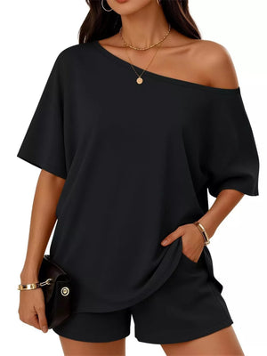 Black boat neck tee and shorts set with off-the-shoulder styling and pockets.