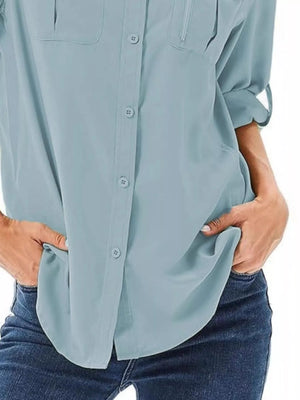 Sky blue button-up shirt with roll-up sleeves and chest pockets.