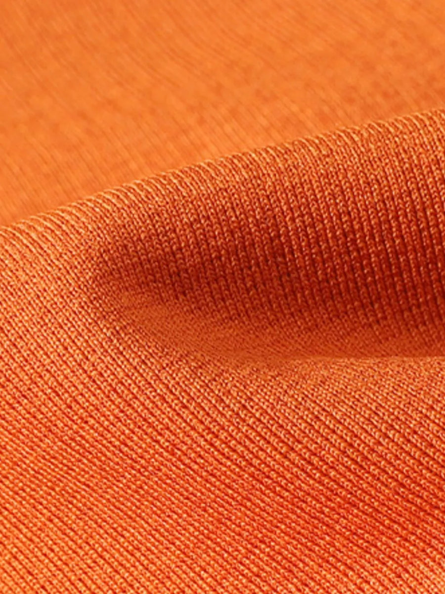 Orange long sleeve crew neck undershirt with ribbed texture.