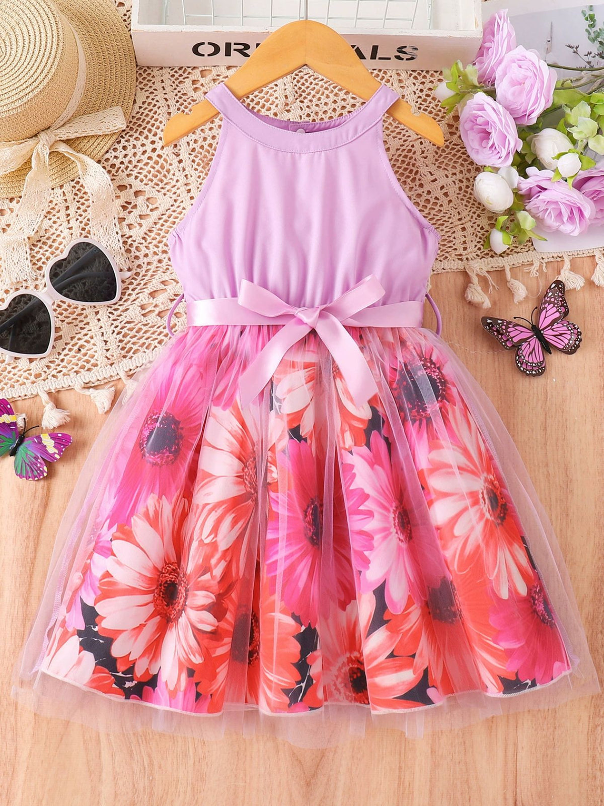 Floral print toddler dress with pink bodice, bow, and full skirt.