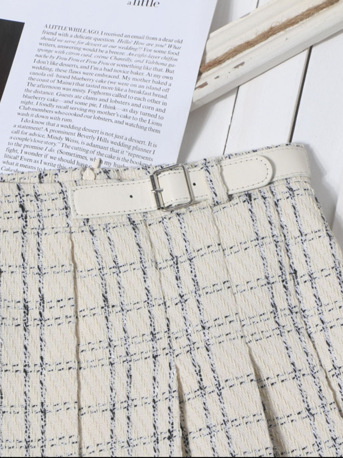 Beige plaid mini skirt with pleats and a white belt detail