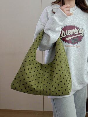 dark brown handbag featuring polka-dot print and polka dot