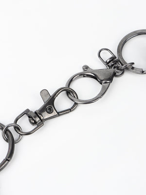 Spiked chain harness belt in black aluminum with lobster clasps and keyring details.