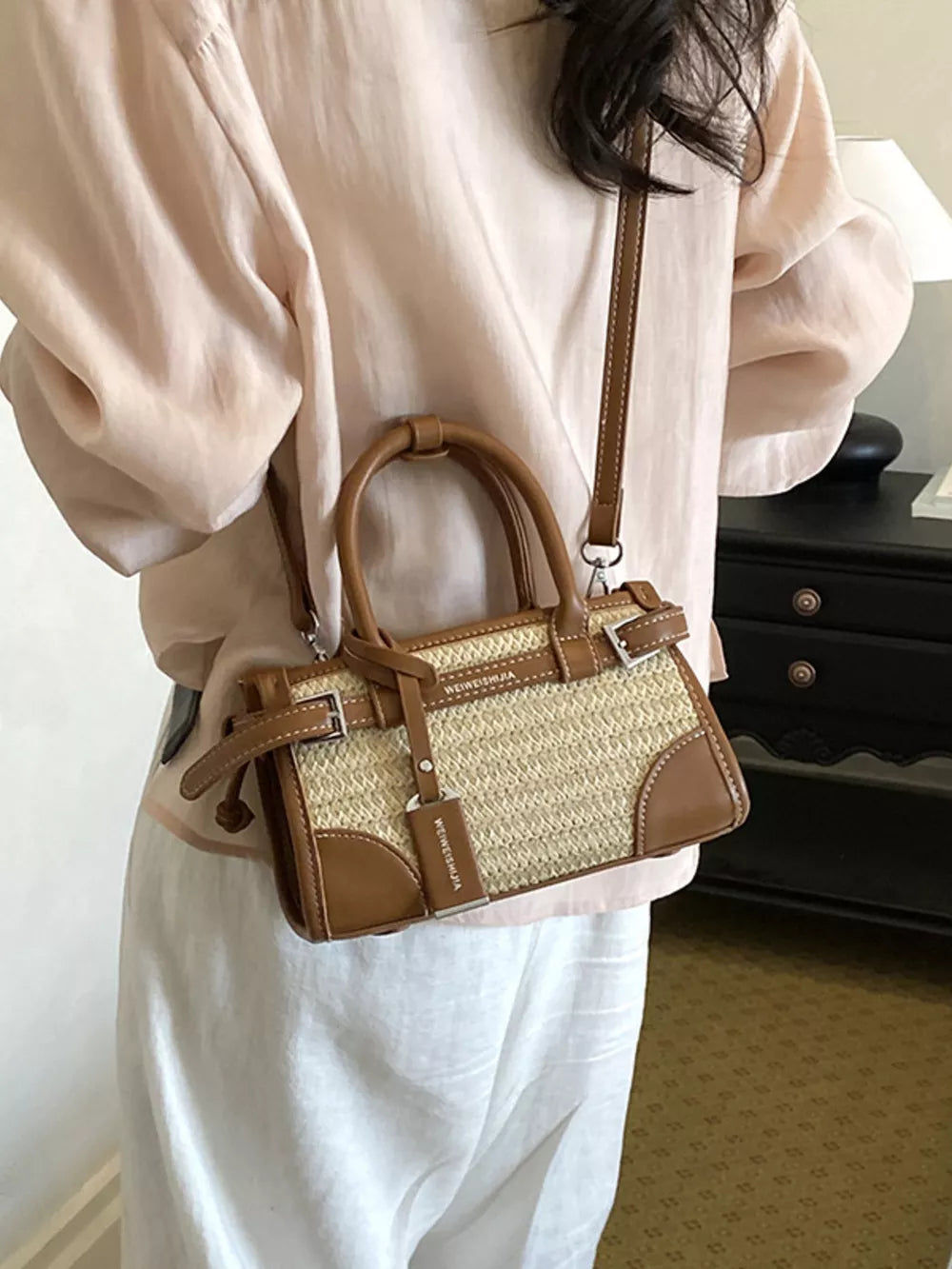 brown crossbody bag featuring adjustable strap and woven