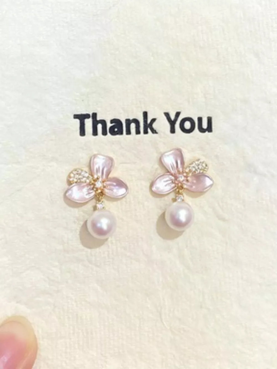 Charming pearl blossom drop earrings with delicate pink petals and sparkling accents.