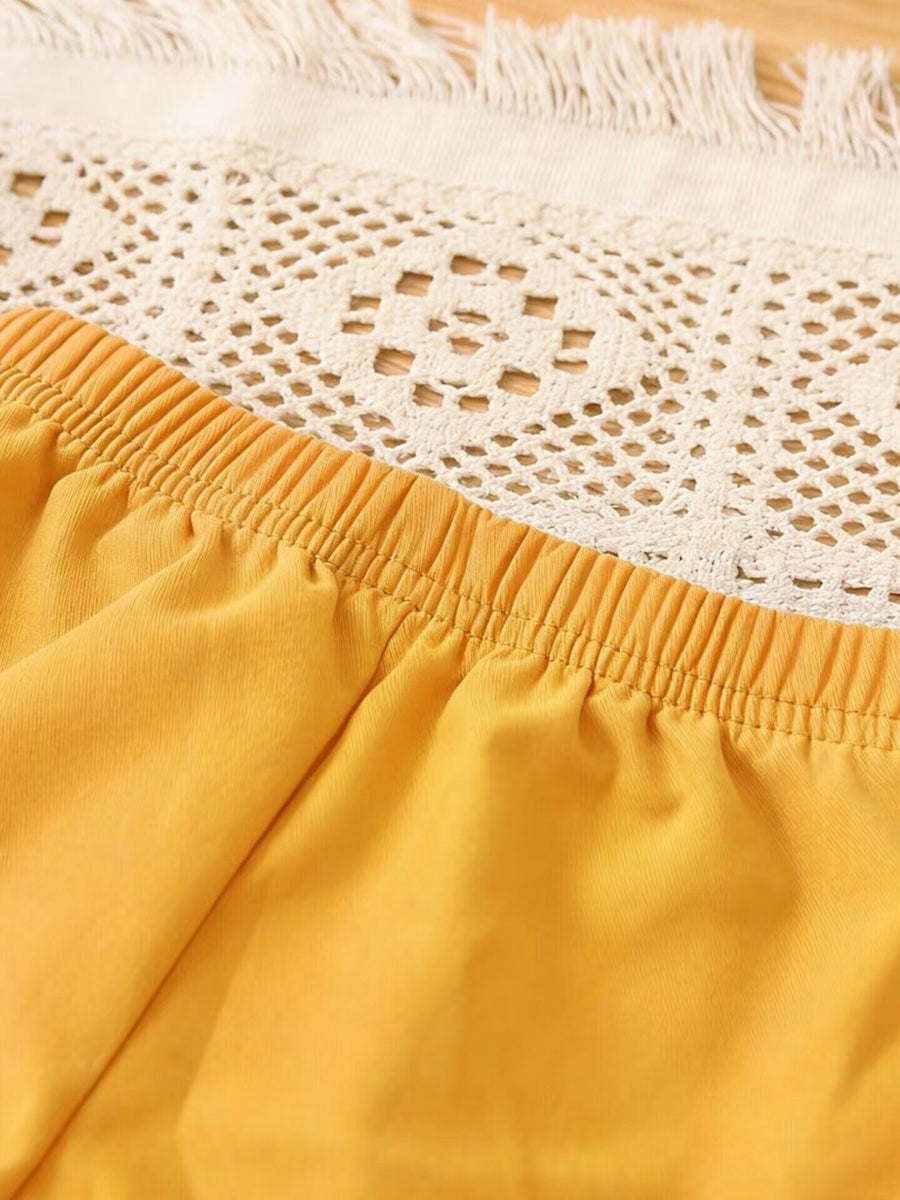 Yellow cotton baby shorts with elastic waistband and lace trim detail.