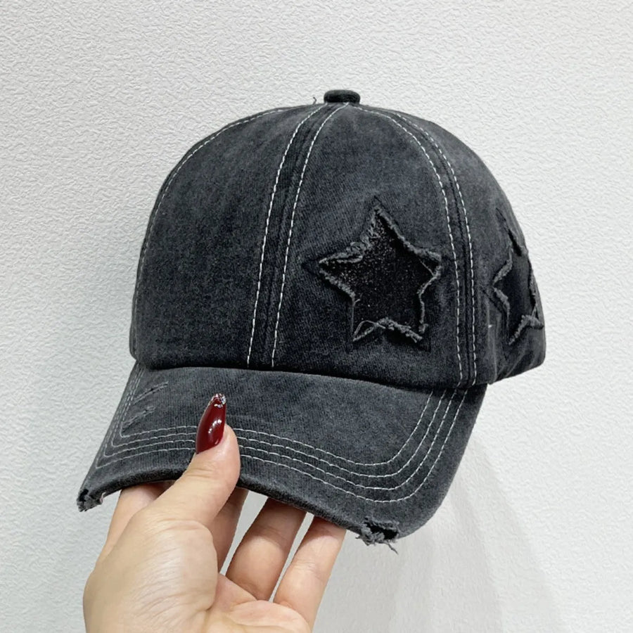 Black distressed baseball cap with embroidered stars and white contrast stitching.