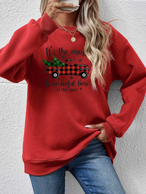 Red crewneck sweatshirt with buffalo plaid truck and Christmas tree graphic.