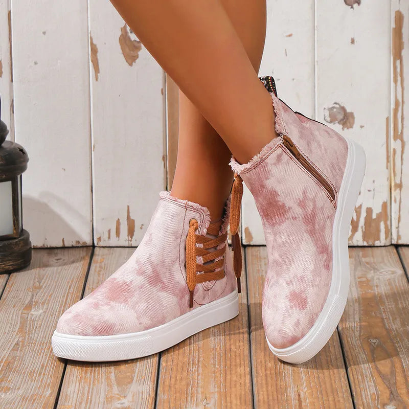 Canvas camo zip-up sneaker booties in blush pink with lace-up detail and frayed edges.