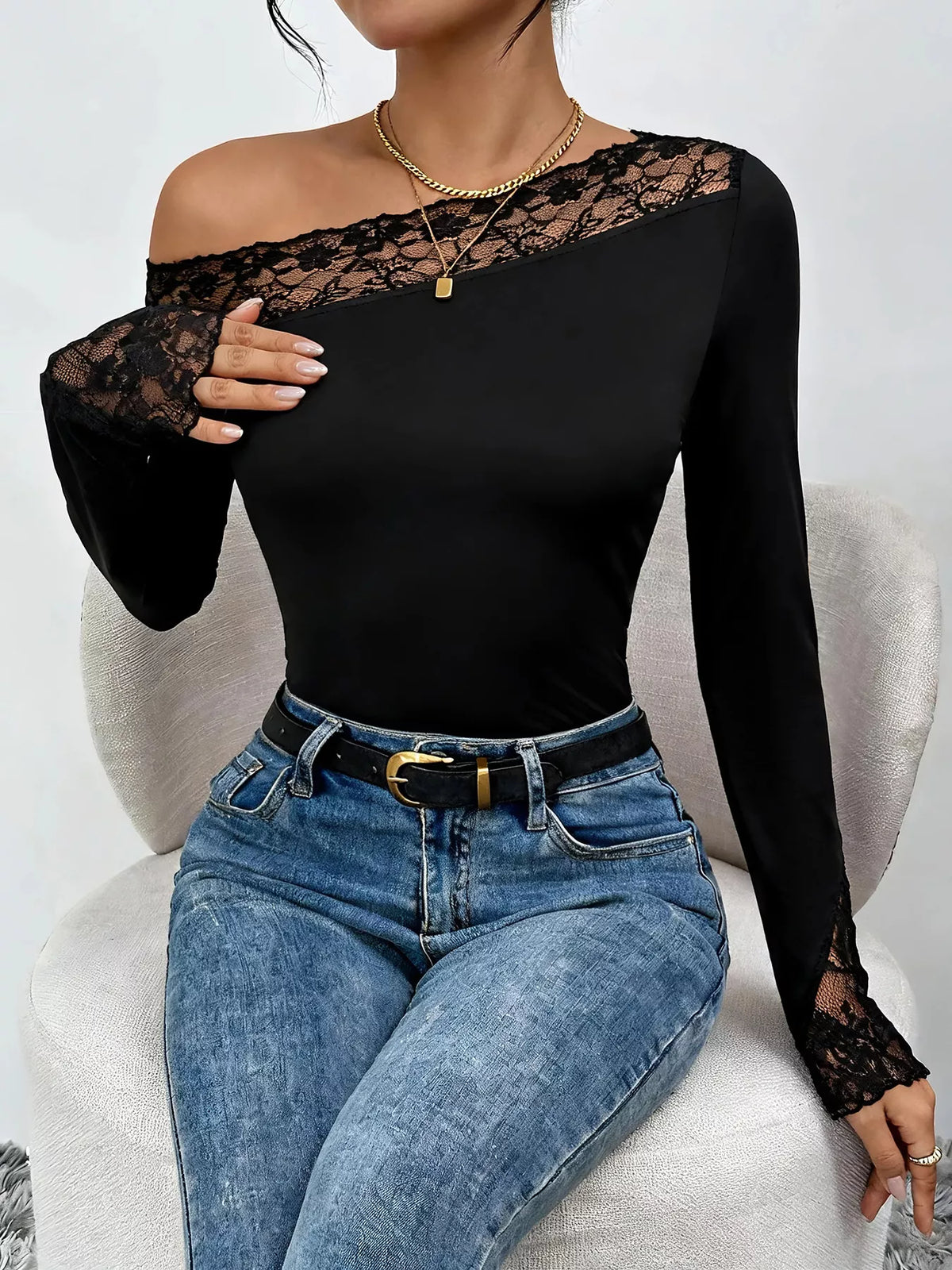 Black lace trim one shoulder bodysuit with long sleeves and elegant lace details.