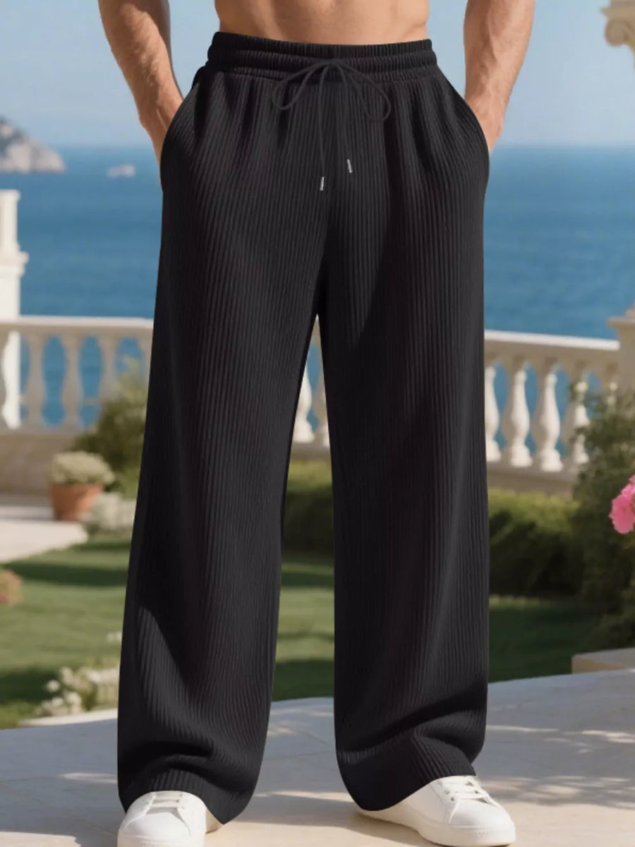 Black ribbed drawstring sweatpants with a relaxed fit and wide leg.